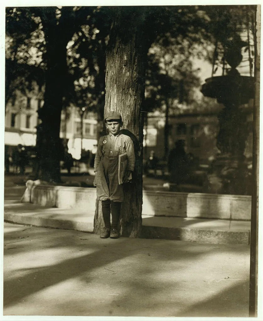 Newsboy in Park. Burlington, Vt.  Location: Burlington, Vermont, 1910