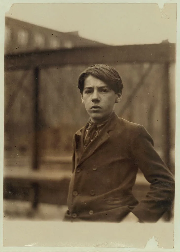 Doffer in Pacific Mill[s], Sime Leroy, 16 years (looks 13). …, Massachusetts, 1910