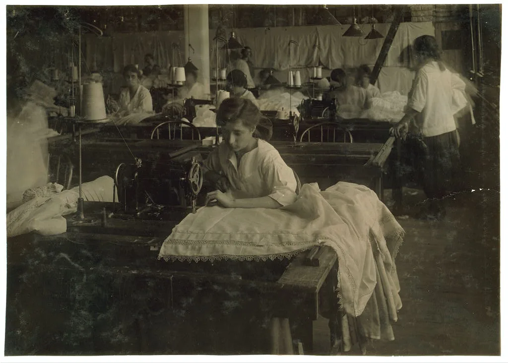 Gertrude Belier, 15 years old. Hemming curtains on machine at…, Massachusetts, 1917