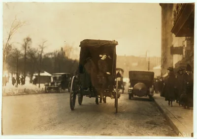 [P.M. Delivery boys on Tremont Street, "getting a hitch."]  Location:…, Massachusetts, 1917