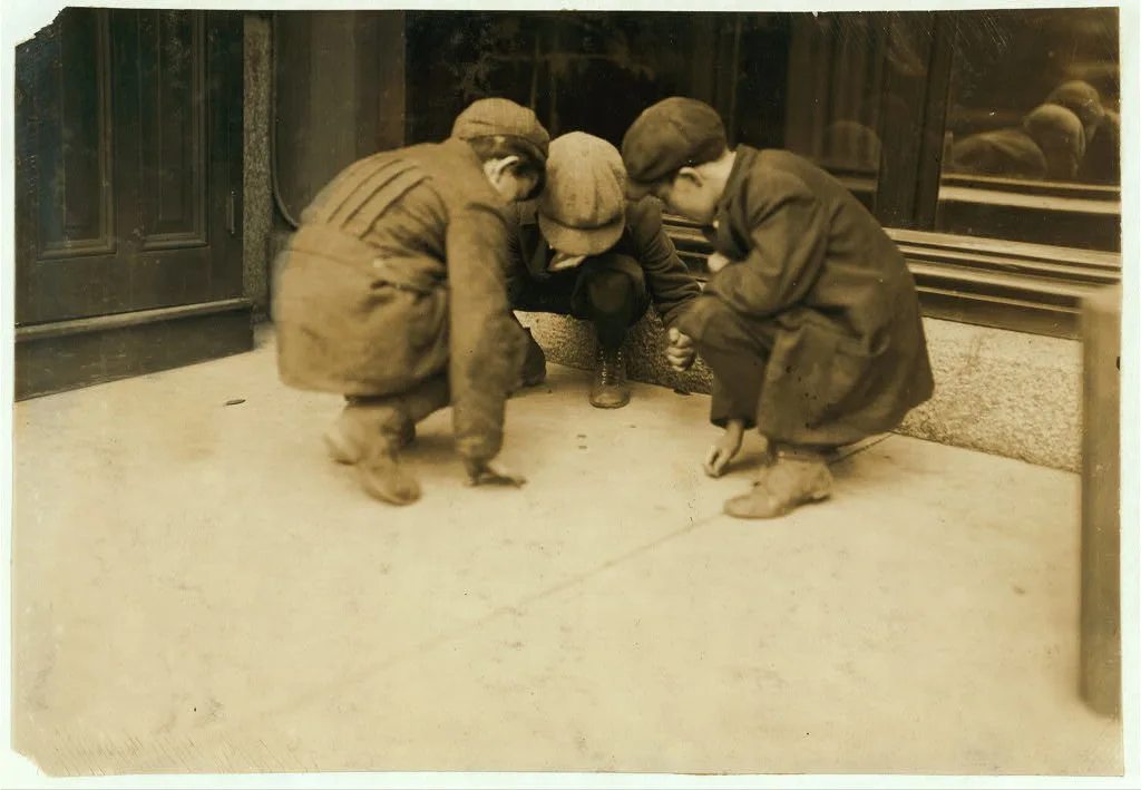 [Mill boys pitching pennies on the Main St. in the afternoon. One…, Massachusetts, 1916