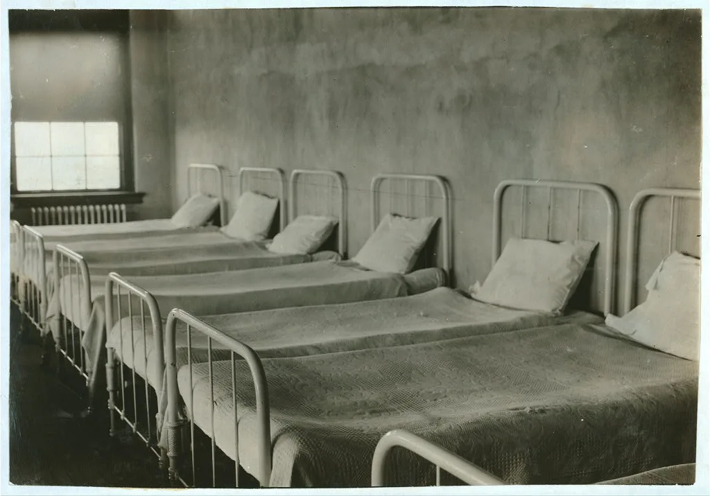 Crowded dormitory (one wall) in Training School for Deaf Mutes. See…, Oklahoma, 1917