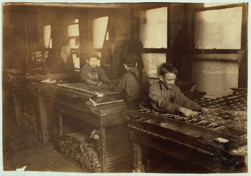 [Boys "linking" bed-springs. 14 and 15 years old.]  Location:…, Massachusetts, 1917